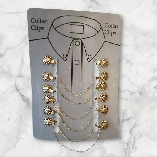 Gullfarget collar clip med solmotiv